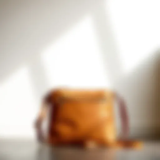 Stylish camel color crossbody bag against a minimalist background