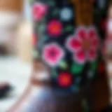 A close-up view of intricate floral embroidery on a cowgirl boot