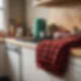 A cozy kitchen adorned with buffalo plaid towels hanging on the stove.