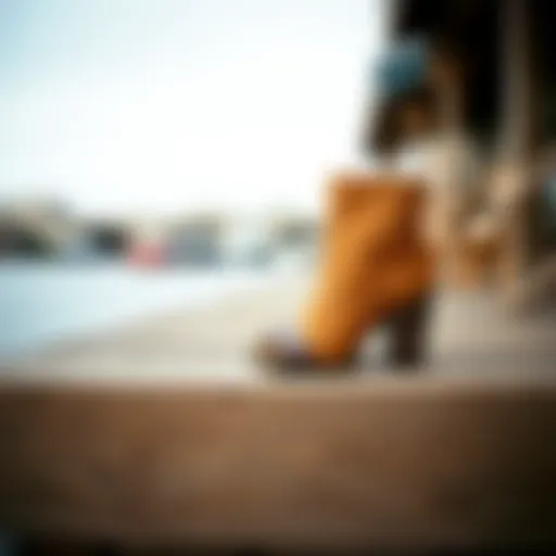 Stylish camel peep toe booties on a wooden surface.