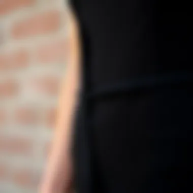 Close-up of fabric texture and details of a black skin tight jumpsuit