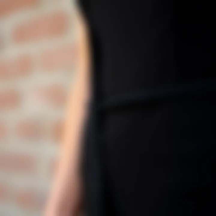 Close-up of fabric texture and details of a black skin tight jumpsuit