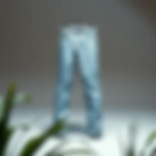 A pair of tapered light wash jeans displayed on a minimalist background.